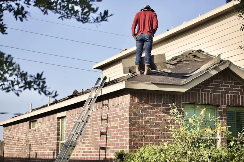 Professional roofer working on a residential roof in Marsh Run